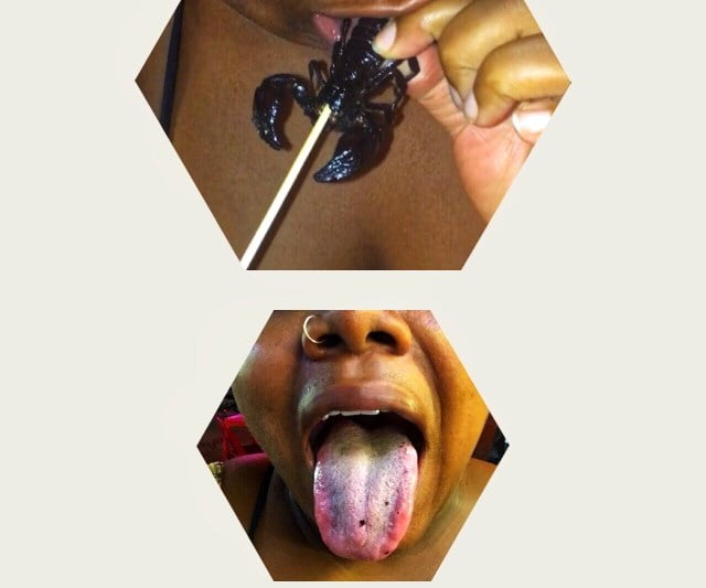 Meredith eating a scorpion in khmer