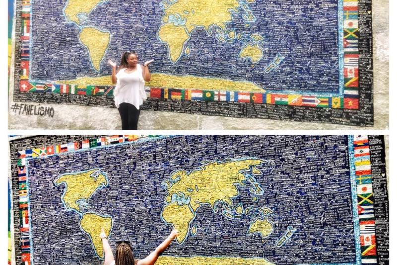 Meredith trying to determine where to travel in the world and using a world map on a wall as a guide
