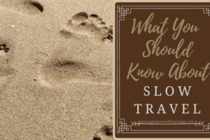 What you should know about slow travel a pin by Meredith with footprints in the sand as a background photo