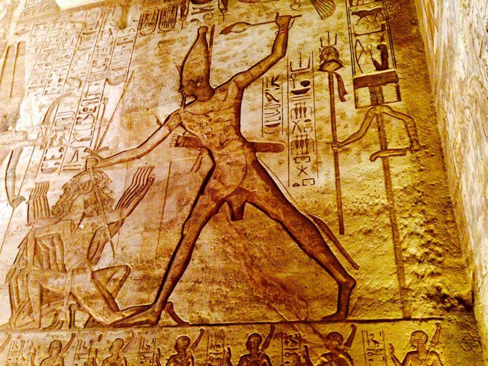 ancient egyptian hieroglyhs on yellow brown wall