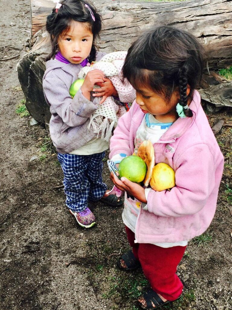 Giving the blessings of citrus to some local children while hiking the Lares Trek