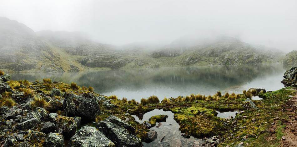 the green lagoon with mist over the lake along lares trek