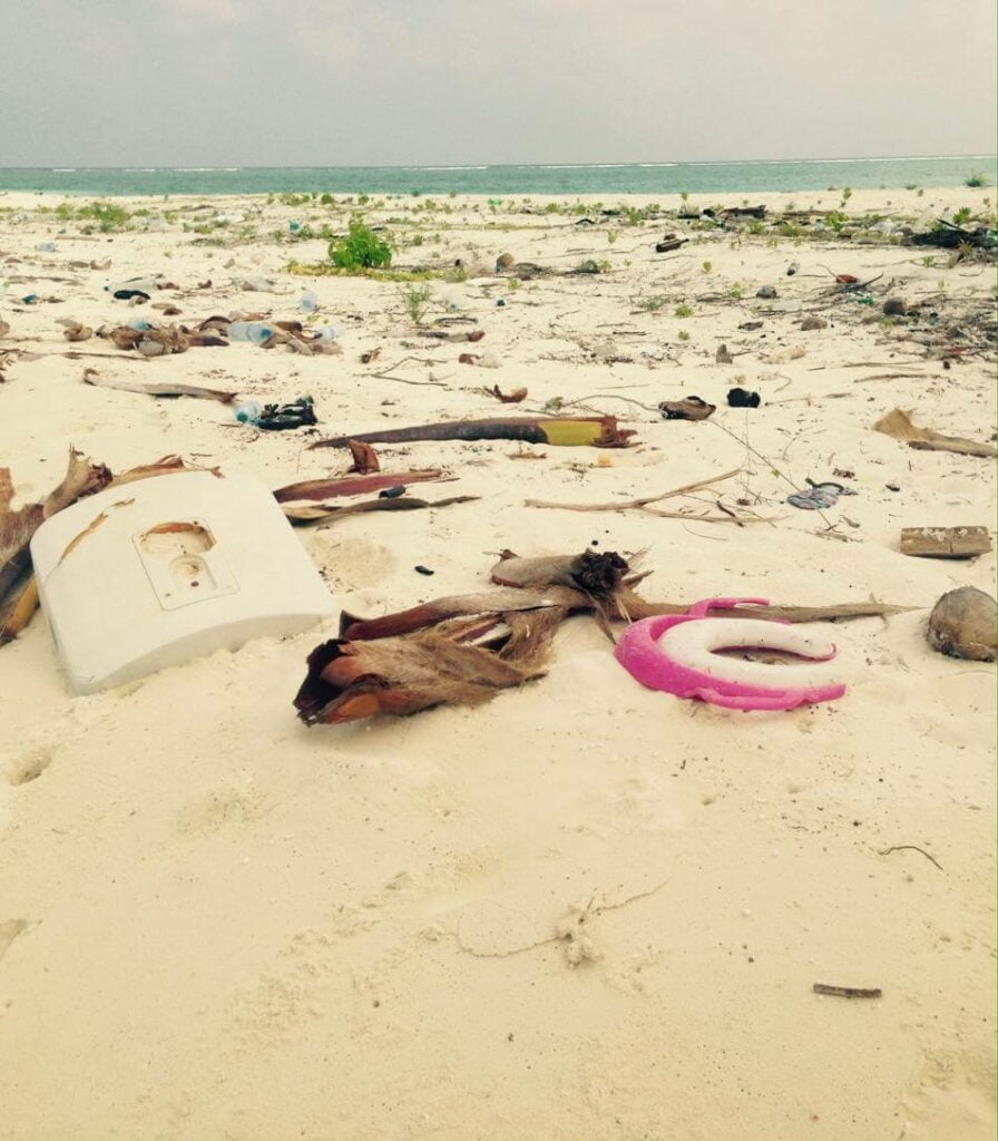 plastic items polluting uninhabited island beach